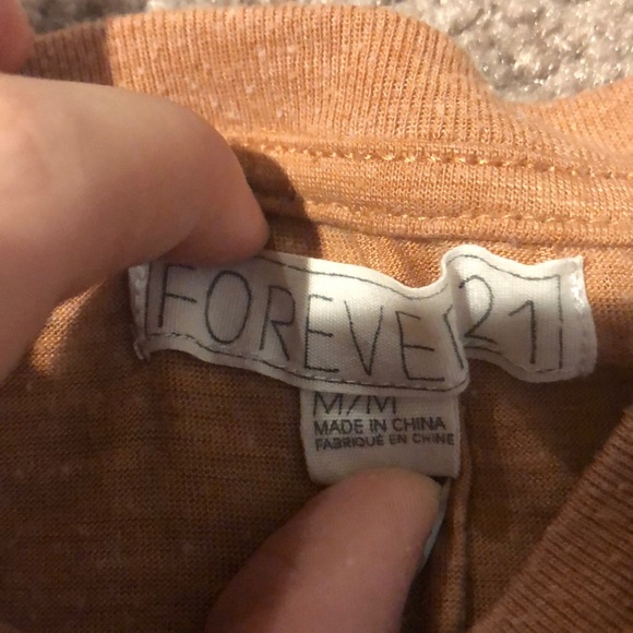 A orange crop top that says rebel spirit on it - Picture 2 of 2